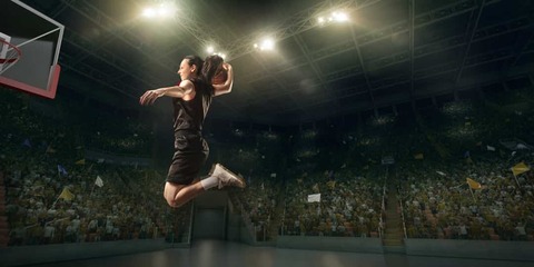 Female basketball player makes slam dunk