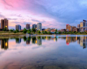 Wolkenkrabbers van Birmingham in Alabama weerspiegeld in kalm water onder een roze en blauwe avondlucht