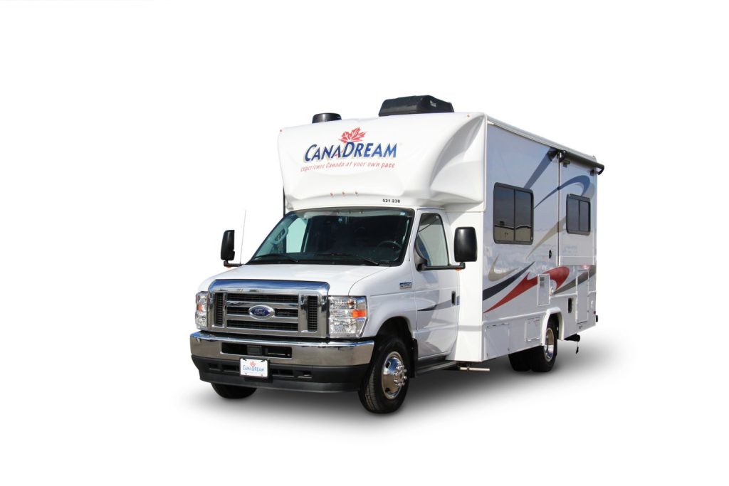 Studiofoto van een witte CanaDream camper met een blauw kenteken op de bumper tegen een witte achtergrond