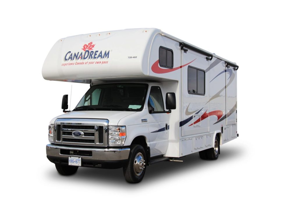 Studiofoto van een witte CanaDream camper met de tekst experience Canada at your own pace op de zijkant