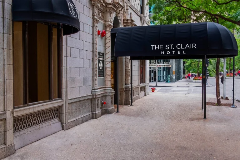 Zwarte luifel met de tekst The St. Clair Hotel boven de ingang van een hotel aan een straat in Chicago