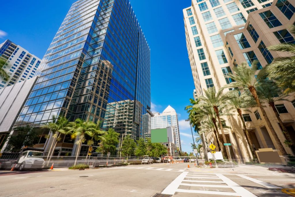 Brede kruising tussen glazen kantoortorens en palmbomen in het centrum van Fort Lauderdale
