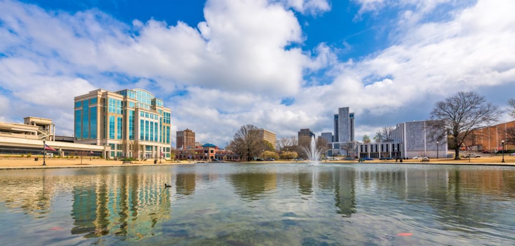 Wolkenkrabbers en kantoorgebouwen van Huntsville weerspiegelen in het water van de vijver in Big Spring Park met een fontein