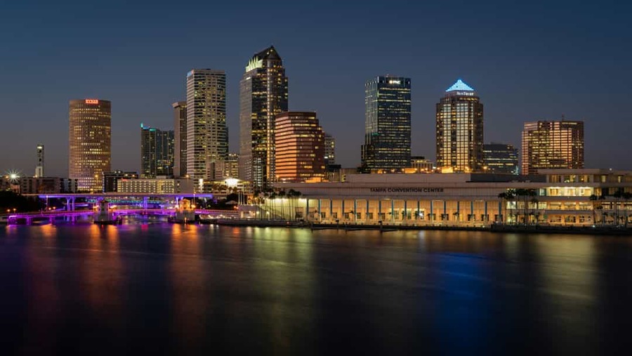Verlichte wolkenkrabbers van Tampa weerspiegelen in het water met het convention center aan de kade