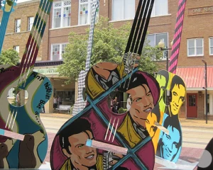 Grote gitaarvormige kunstwerken beschilderd met portretten van Elvis Presley opgesteld op straat in zijn geboorteplaats Tupelo in Mississippi