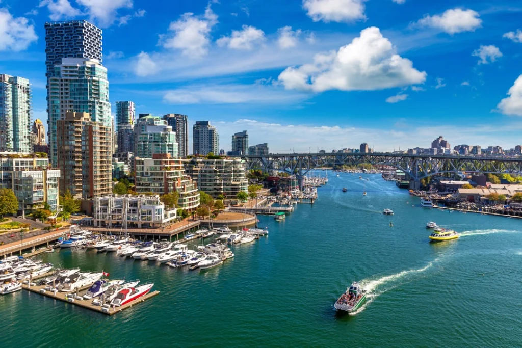 Luchtfoto van Vancouver met wolkenkrabbers, een drukke jachthaven vol boten en een brug over de waterweg